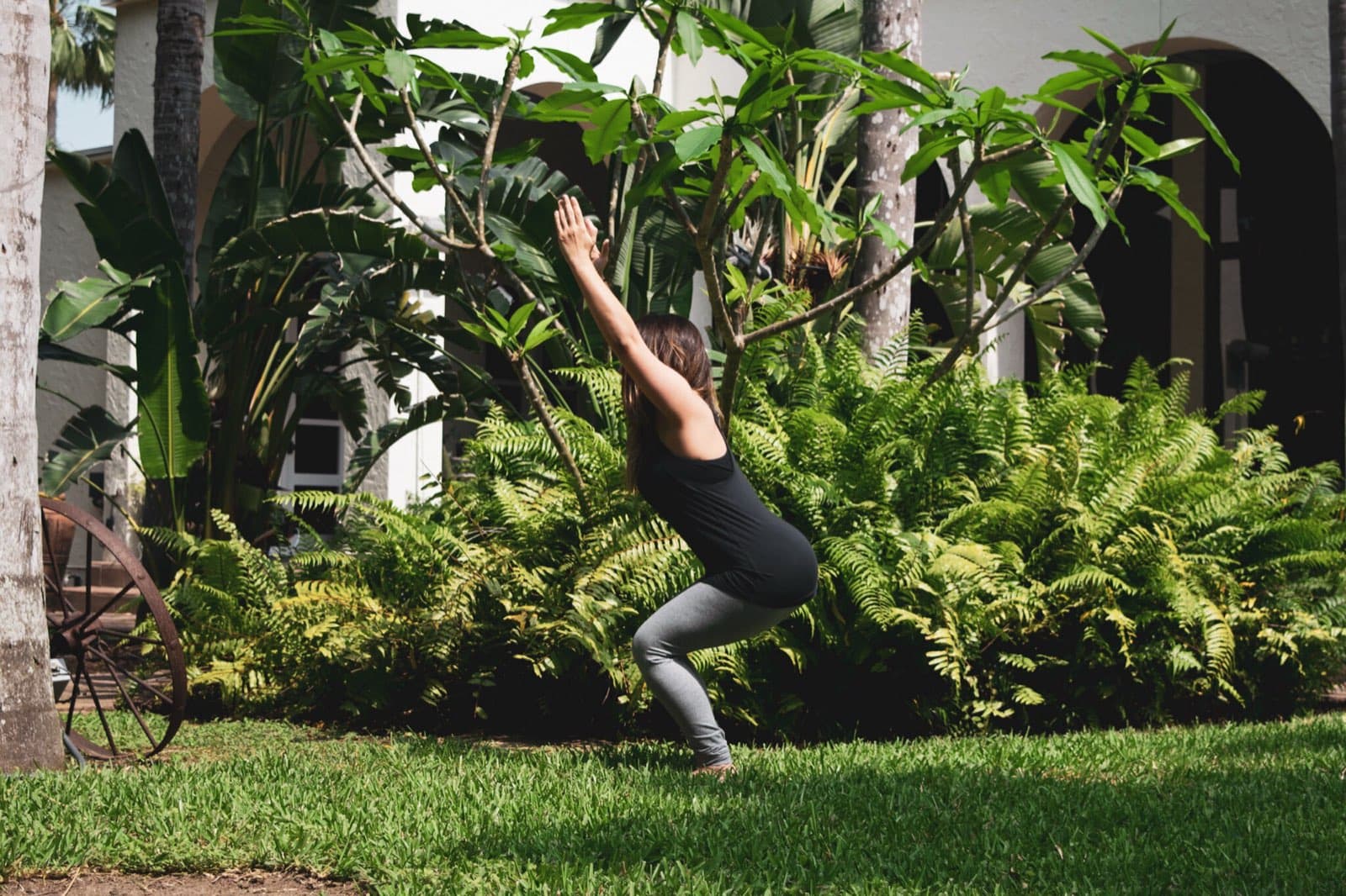 Yoga instructor Bernardette Hernandez demonstrating a chair pose used to build hip and leg mobility for skiing and snowboarding.