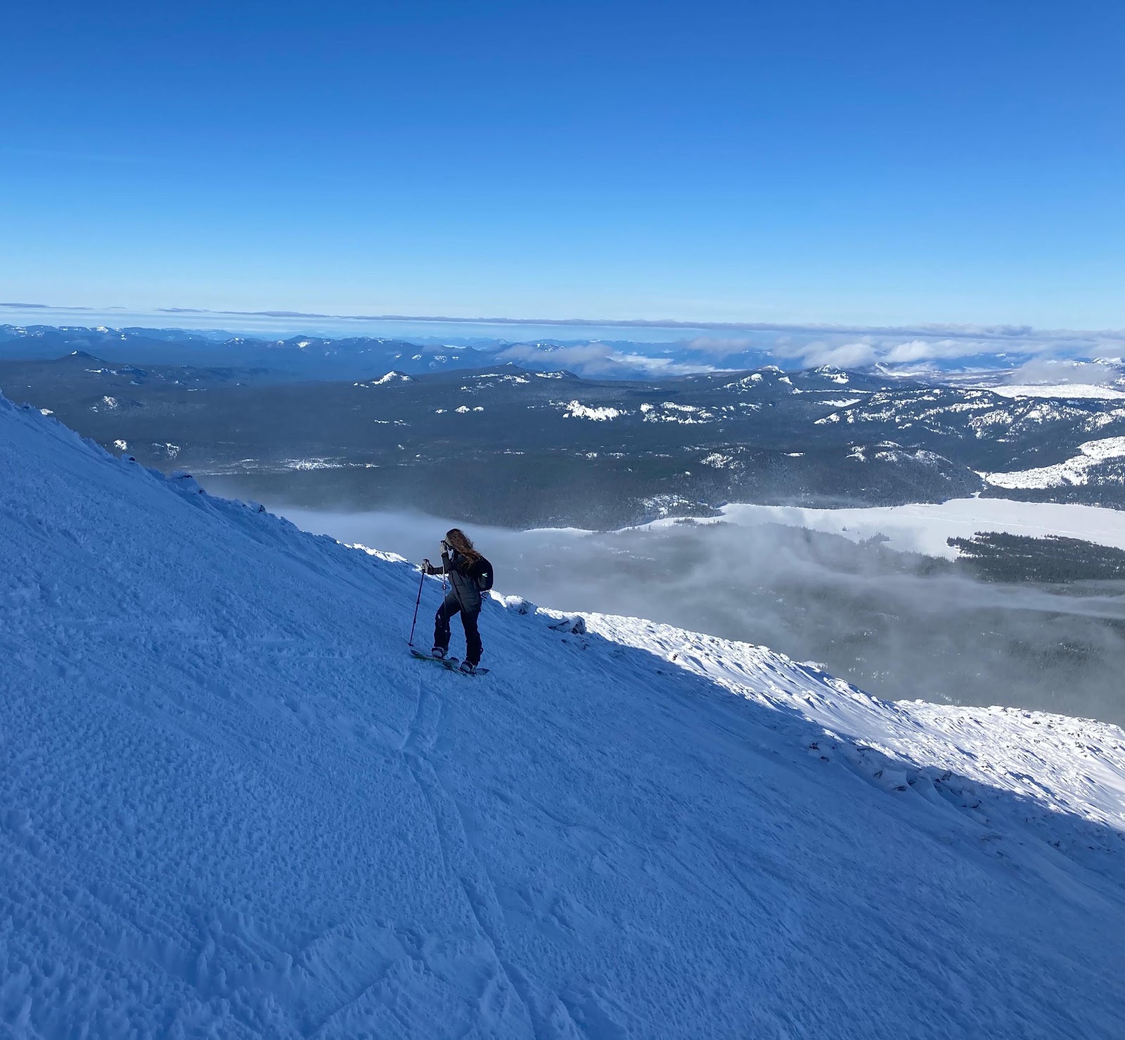 Two skiers riding down a snowy mountain slope together